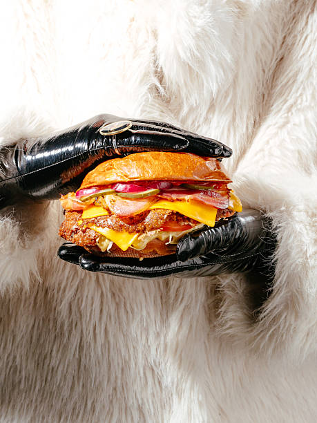 A woman is holding a large sandwich in her hands
