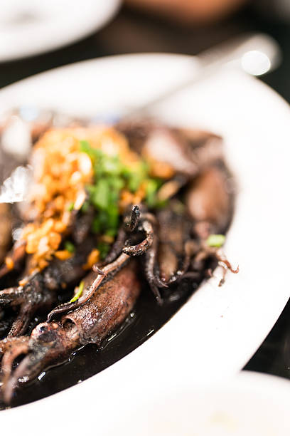 Stir fried black squid menu on the white dish.
