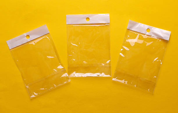 Transparent cellophane bags mockup on yellow background