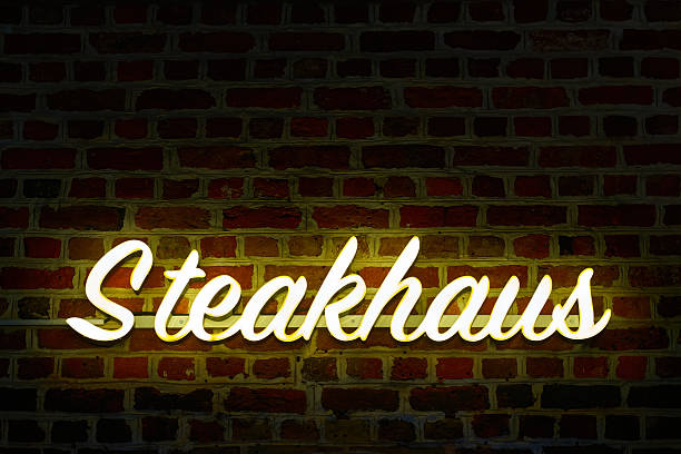 Neon sign for a steakhouse in a German old town in the evening
