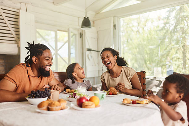 istock Cheerful black family having fun during breakfast at dining table. 2256186768