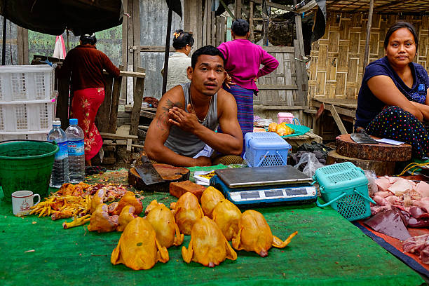 mandalay, Myanmar - Feb 25, 2016. Small traders buying and selling in a traditional market in Mandalay, Myanmar.