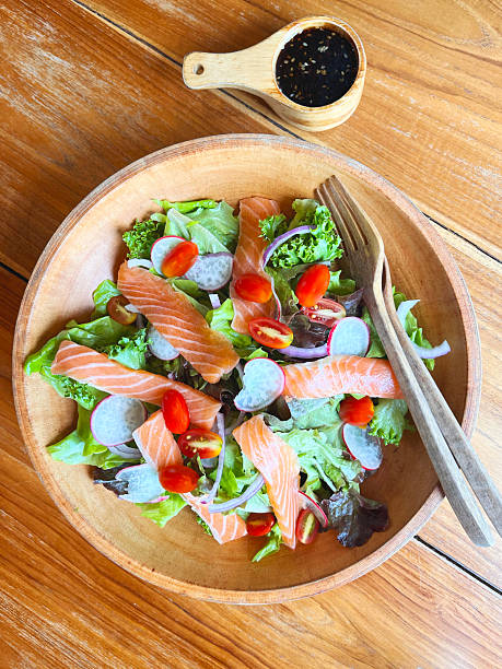 Salmon salad bowl with green vegetables for diet food.