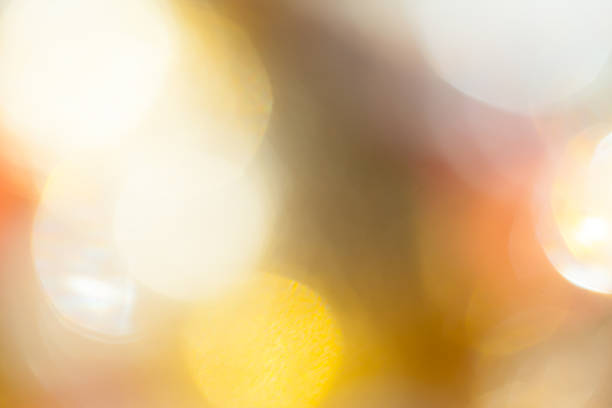Bright lights form soft shapes and colors in a blurred background at night.