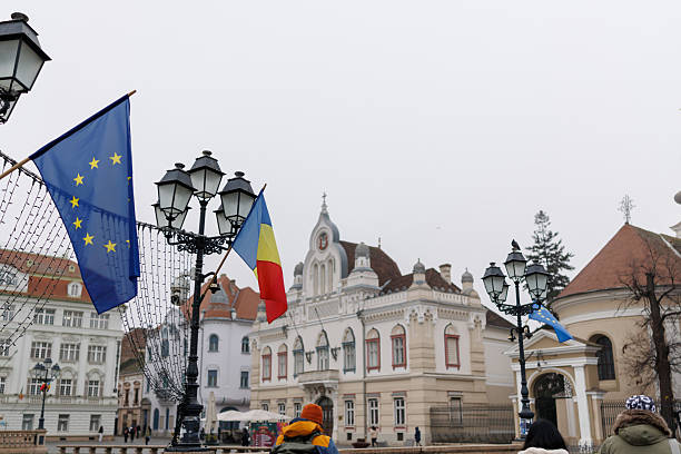 Rear view shot of three mature friends tourists exploring old European town during winter vacation