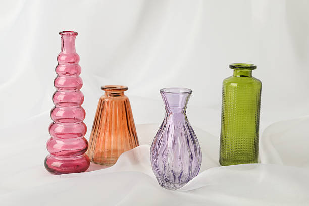 istock Different beautiful glass vases on white cloth 2256209562