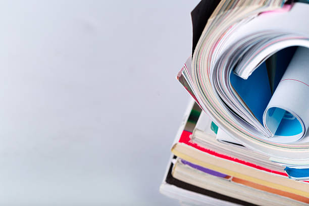 Magazines are stacked with colorful covers and pages partially visible.