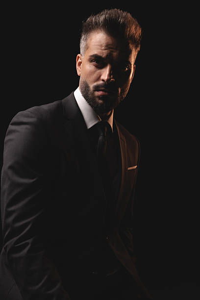 istock Serious mysterious man posing in the dark 2256220180
