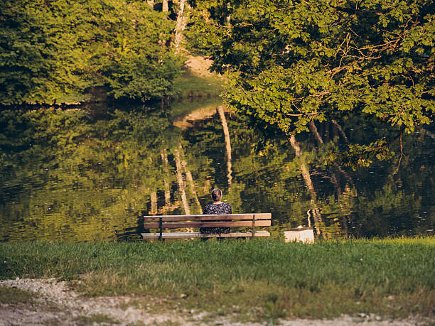 relaxing on a bench at a lake