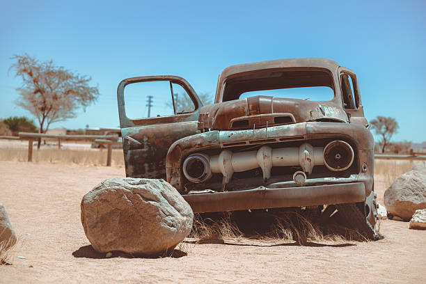 abandoned vintage car wreck resting in the sand of Namib dessert