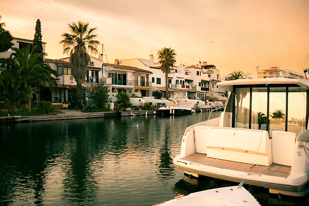 Port of Malaga. A luxury yachts are anchored in a marina with a lighthouse nearby, surrounded by palm trees, evoking a peaceful coastal setting and a relaxed lifestyle.