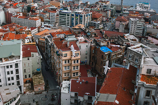 Istanbul, Turkey – November 27, 2013: Panoramic view of Istanbul city rooftops and waterfront under cloudy skies.