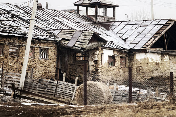 Dying mountain villages (aul) in the Caucasus. Dilapidated houses in winter. Poor farms