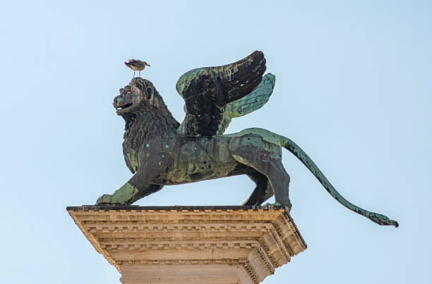 Winged lion sculpture (symbol of Venice) on San Marco column at St. Mark's square, Venice, Italy