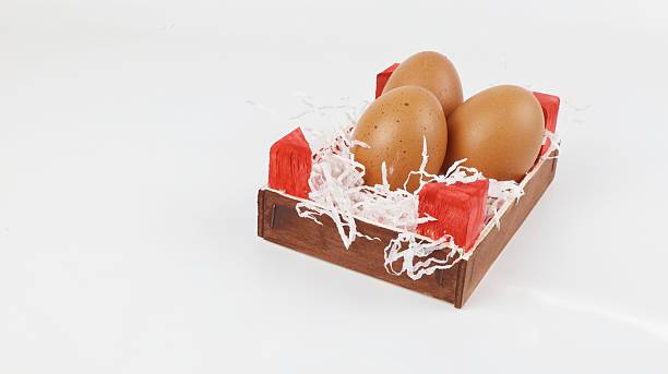 Chicken eggs to cook, in a wooden box.