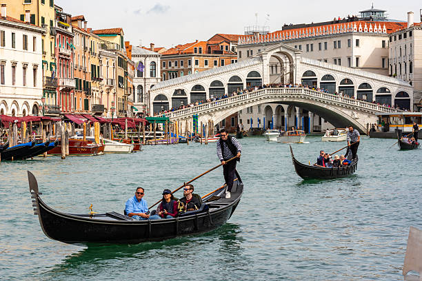 Venice, Italy - 01 October 2025: Tourists sailing in gondola on Grand canal in Venice