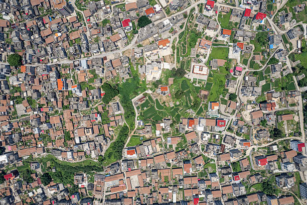 Vertical view of dense houses and sparse fields on the plain