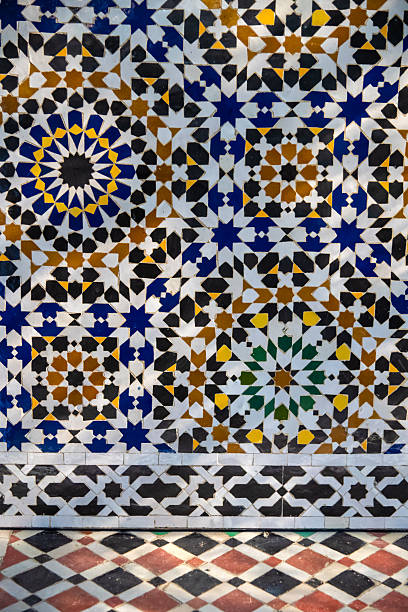 Vibrant Moroccan tile wall from Fez featuring intricate geometric patterns, star motifs, and a rich color palette. Perfect for projects invoking heritage, craft, travel, and cultural artistry.
