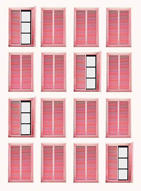 Many Windows frames as pattern on light beige color wall with wooden pink shutters, geometric design home facade design. Minimal pastel aesthetics, retro style summer travel background. creative print