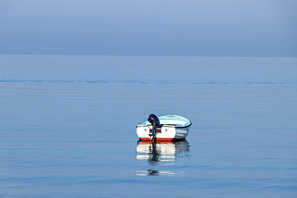 An floating boat on calming sea