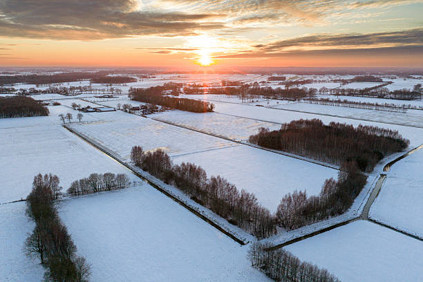 istock Sunset over a snowy winter landscape 2256252311