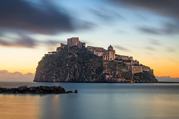 Ischia, Italy with Aragonese Castle in the Mediterranean at dawn.