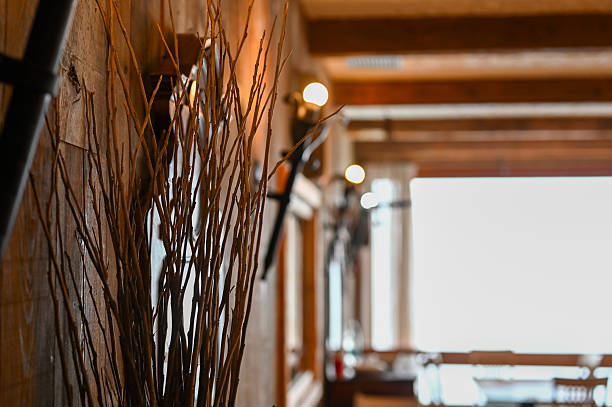 Dried branches decorating a cozy wooden interior with warm light