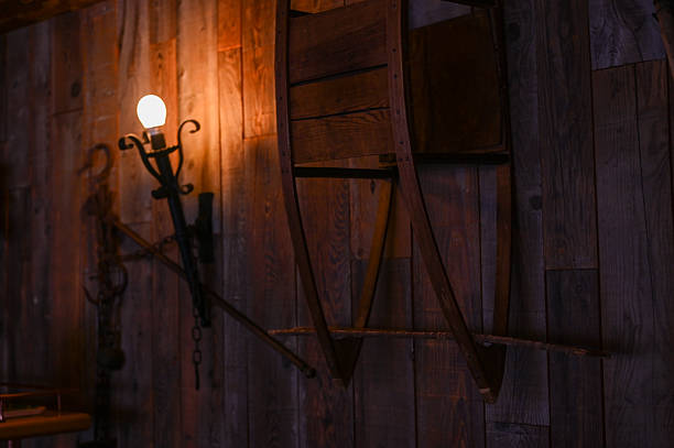 Beautiful wall lamp illuminates on the old wallpaper in dark room