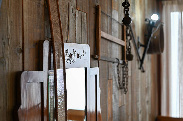The head, antlers and neck of a taxidermic moose hangs on a stone wall over a fireplace inside a home.