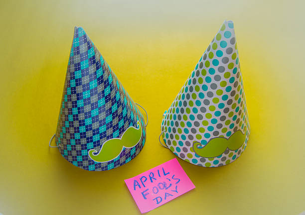 This is a photograph of a sombrero and two maracas on a colorful Slated Wood Background next to a sombrero
