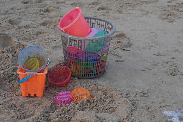 Plastic sand castle making bucket, shovel, sieve, molds all packed in net ready for children to play with on the markets of Goa