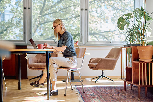istock Woman working on laptop from her stylish home office 2256264334