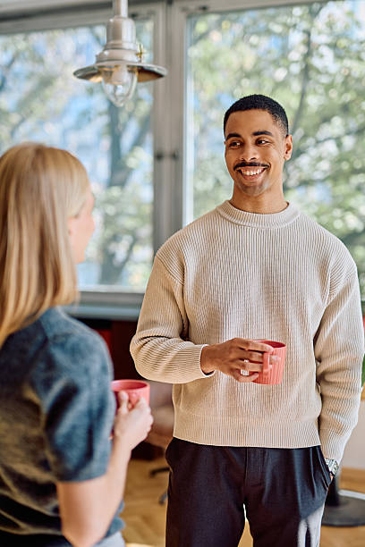 Coworkers enjoying coffee break having conversation