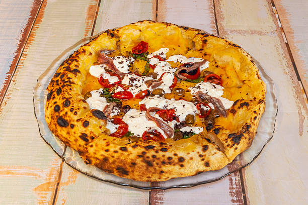 The anchovy and caper pizza offers bold Mediterranean flavors with red onion and oregano on a tomato base