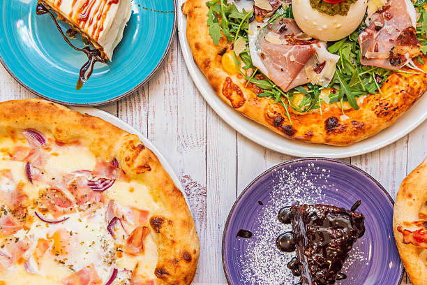 A lamb and mint pizza features spiced lamb with a yogurt and fresh mint sauce on a hummus base