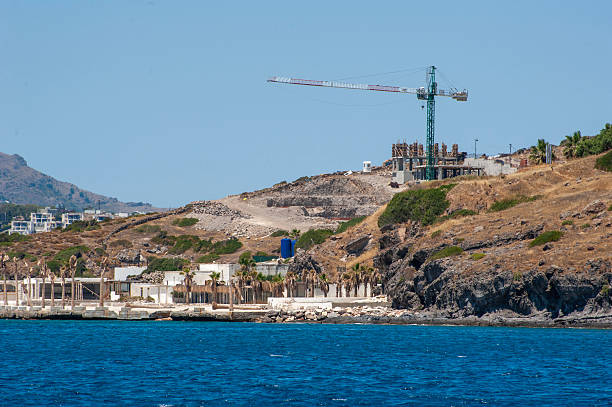 Bodrum coast view with construction site with crane industrial equipment