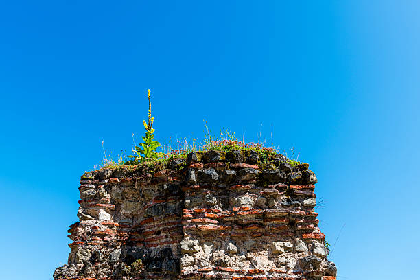 part of old ruin in front of a clear blue sky