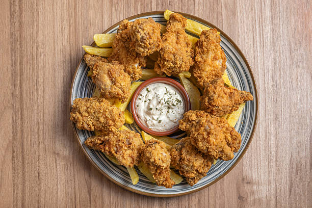 an overhead shot shows a bountiful and messy feast, complete with cold beer bottles and used napkins, capturing the essence of a lively and informal gathering.