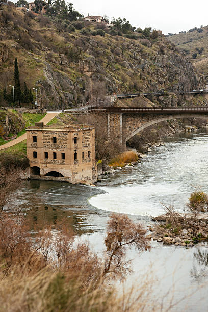 istock Ancient stone building by the Tagus River with a stone bridge in the background, Toledo. 2256300159