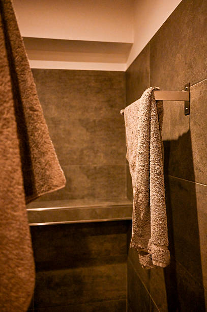 Close up of woman arm making gesture of taking towel in bathroom with marble background