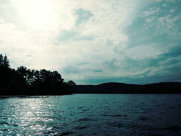 A blue water lake in the woods of Harriman State Park on a sunny October day.