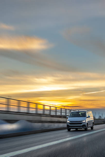 Vitoria-Gasteiz, Basque Country, Spain. Delivery van in motion driving along a rural road next to a blank billboard available for advertisements.