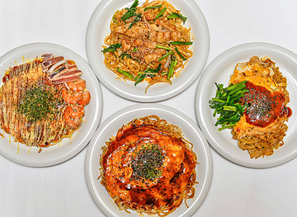 Delicious Asian noodle dishes with seafood and savory sauces isolated on white background
