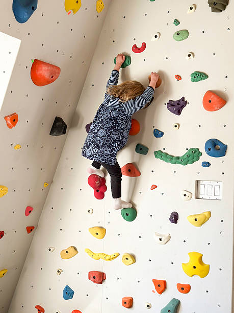 Two year old climbing on a home climbing wall