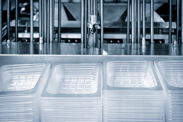 Automatic polyethylene plastic bag production machine with lighting effect. Close-up of the roller of the plastic bag production machine in the light blue scene. product packaging concept