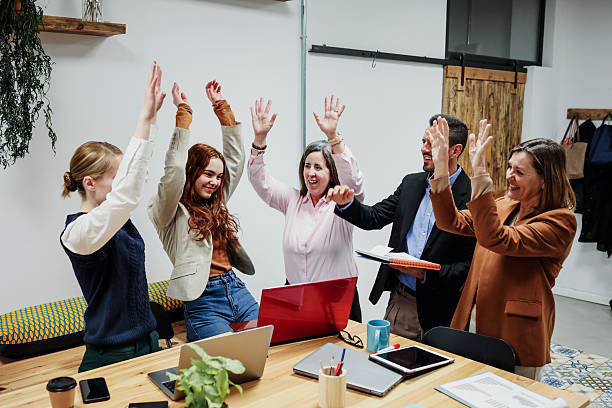 istock hispanic business team with different ages working and using laptop together at office. Diverse Entrepreneurs and multi generational teamwork sharing ideas. 2256314516