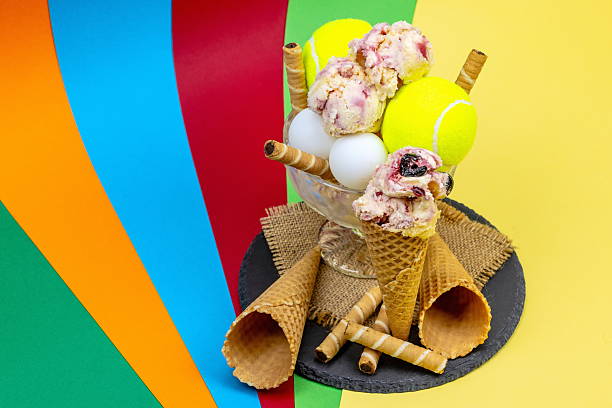 Ice cream cup as a trophy after a tennis match with ping pong balls on a colorful background
