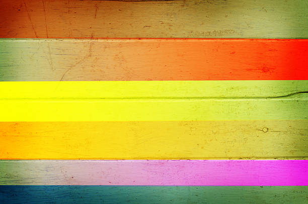 Rainbow multi color on wooden plank background.