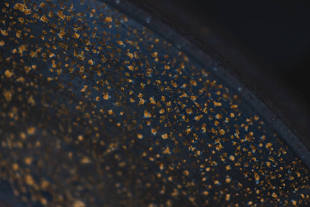 Close-up details of oxidation or rust on the brakes of a car. Metal corrosion, vehicle wear and tear, signs of wet weather affecting vehicle parts.