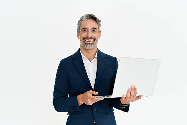 istock Happy mid aged business man using laptop standing isolated on white, portrait. 2256328656